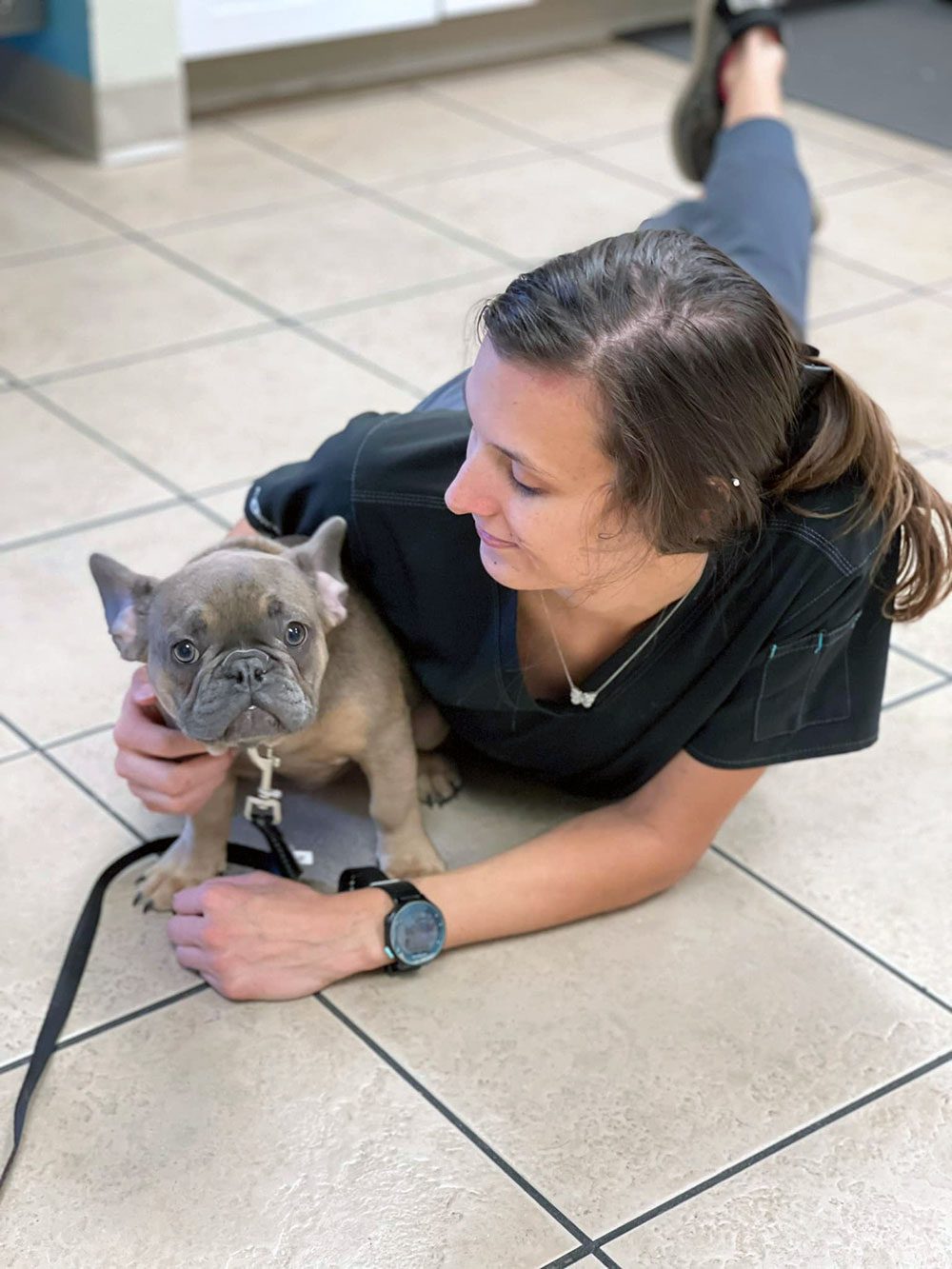 Vet Tech On Floor With Puppy